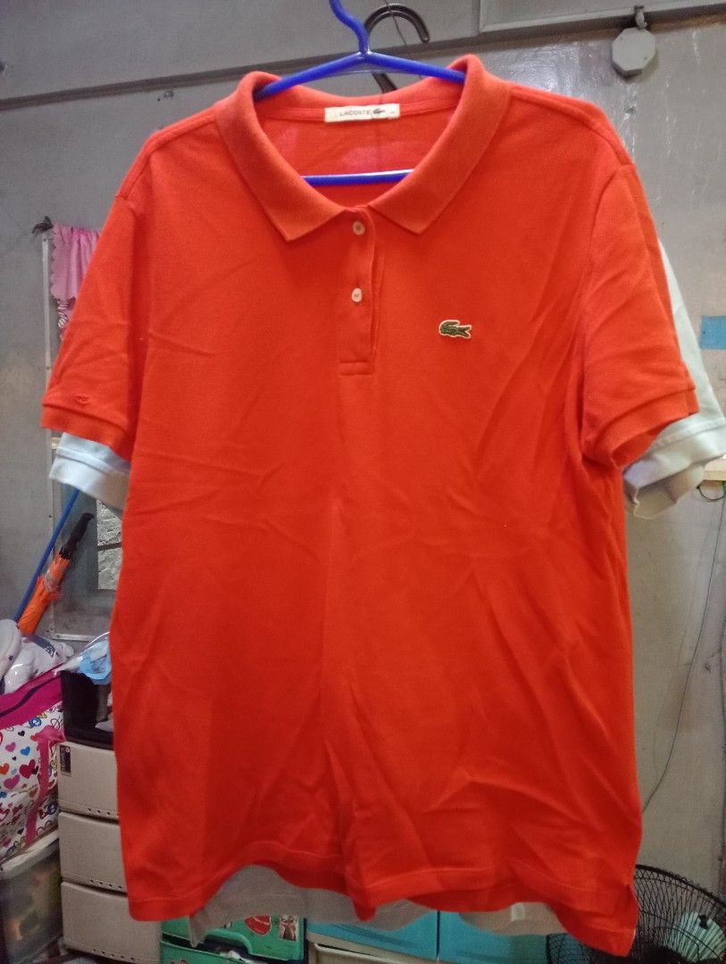 Lacoste Orange Polo Shirt Size 42 (Category: Tshirts & Polo Shirts ) located in Marikina City. Submitted by cosmiccrystal.571e7e (Listing ID 1465417921, Image 1). Description: - Brand: Lacoste - Color: Vibrant bright orange - Material: 100% classic pique knit cotton - Size: 42 - Features: Short sleeves, classic button placket, signature embroidered crocodile logo on the chest - Condition: Excellent pre-loved condition, standard care instructions 