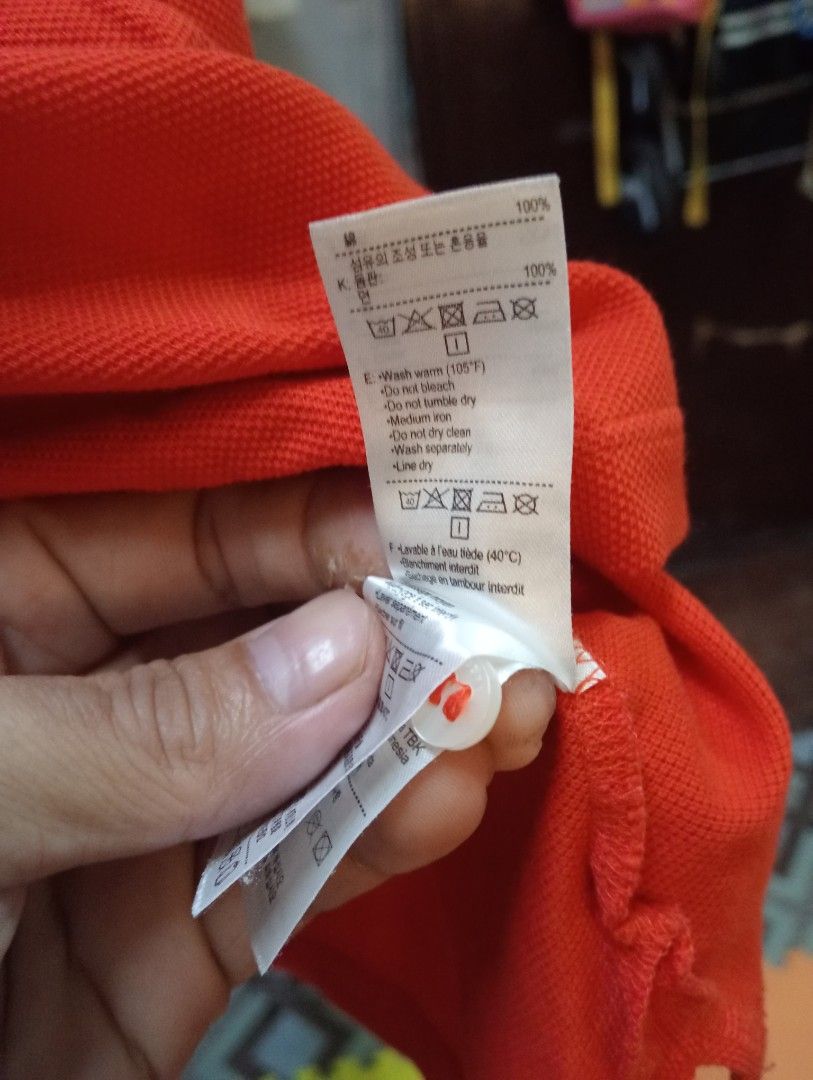 Lacoste Orange Polo Shirt Size 42 (Category: Tshirts & Polo Shirts ) located in Marikina City. Submitted by cosmiccrystal.571e7e (Listing ID 1465417921, Image 3). Description: - Brand: Lacoste - Color: Vibrant bright orange - Material: 100% classic pique knit cotton - Size: 42 - Features: Short sleeves, classic button placket, signature embroidered crocodile logo on the chest - Condition: Excellent pre-loved condition, standard care instructions 