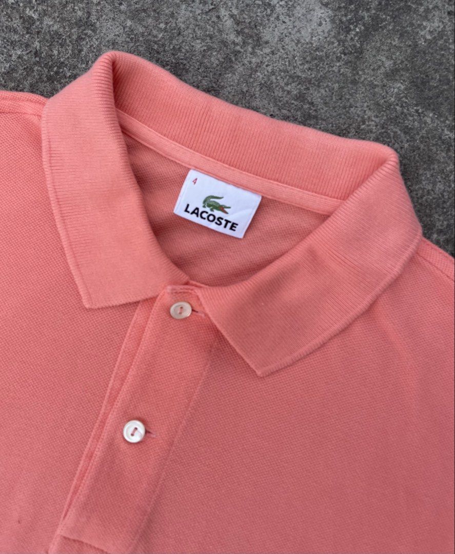 Lacoste Peach Polo Shirt Size 4 (Category: Tshirts & Polo Shirts ) located in Manila. Submitted by ajzeemlimbamidzid (Listing ID 1465512062, Image 3). Description: - Brand: Lacoste - Color: Peach pink - Size: 4 (Tag on collar) - Material: 100% cotton pique - Details: Two mother-of-pearl buttons, embroidered green crocodile logo on chest, Devanlay care label - Origin: Made in Tunisia.