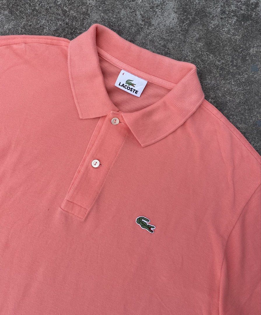 Lacoste Peach Polo Shirt Size 4 (Category: Tshirts & Polo Shirts ) located in Manila. Submitted by ajzeemlimbamidzid (Listing ID 1465512062, Image 2). Description: - Brand: Lacoste - Color: Peach pink - Size: 4 (Tag on collar) - Material: 100% cotton pique - Details: Two mother-of-pearl buttons, embroidered green crocodile logo on chest, Devanlay care label - Origin: Made in Tunisia.