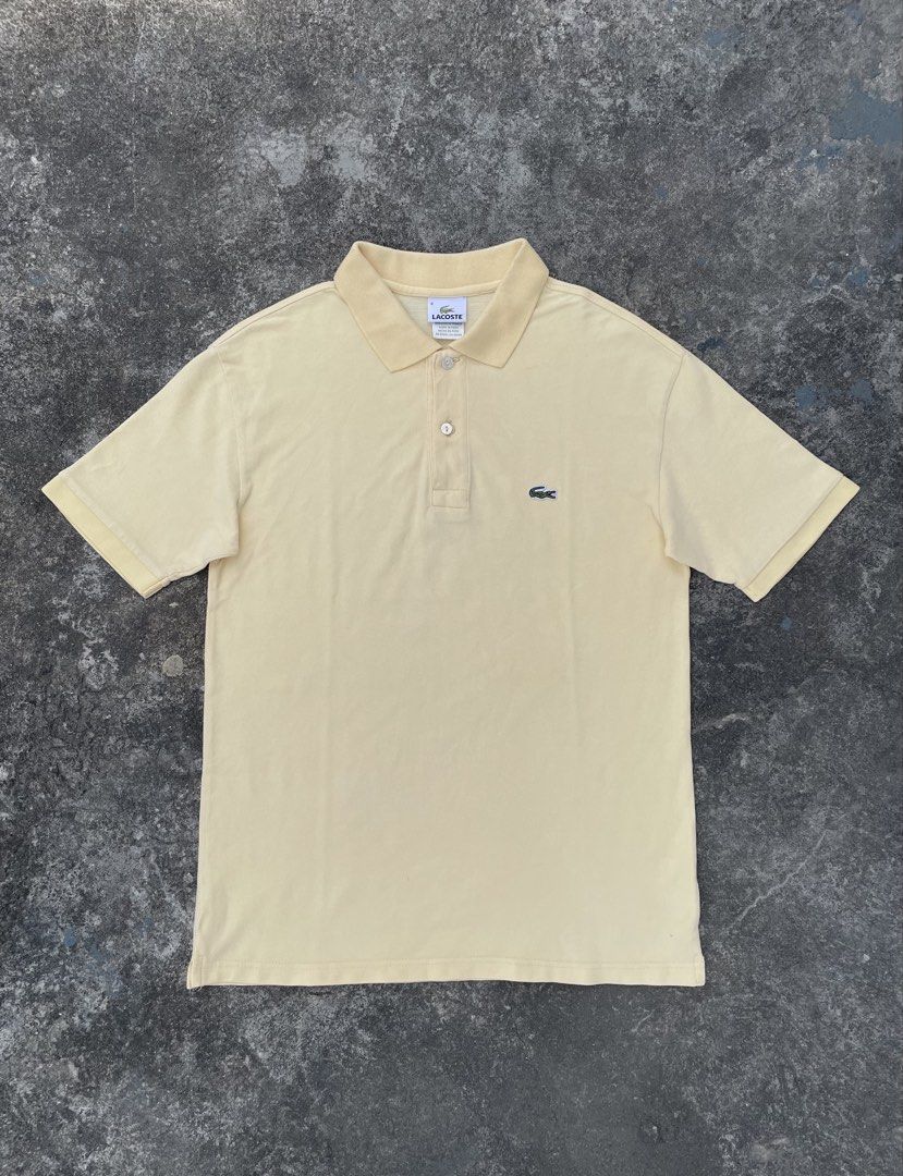 Lacoste Yellow Polo Shirt Size 4 (Category: Tshirts & Polo Shirts ) located in Manila. Submitted by ajzeemlimbamidzid (Listing ID 1465512323, Image 1). Description: - Brand: Lacoste - Color: Soft pastel yellow - Size: 4 (Designed in France, Made in Peru) - Material: Classic breathable pique knit texture - Details: Two-button placket with pearlescent buttons, ribbed collar and sleeve cuffs - Logo: Iconic embroidered green crocodile on the chest - 