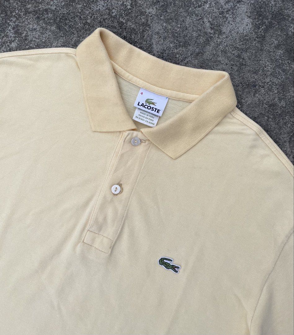 Lacoste Yellow Polo Shirt Size 4 (Category: Tshirts & Polo Shirts ) located in Manila. Submitted by ajzeemlimbamidzid (Listing ID 1465512323, Image 2). Description: - Brand: Lacoste - Color: Soft pastel yellow - Size: 4 (Designed in France, Made in Peru) - Material: Classic breathable pique knit texture - Details: Two-button placket with pearlescent buttons, ribbed collar and sleeve cuffs - Logo: Iconic embroidered green crocodile on the chest - 