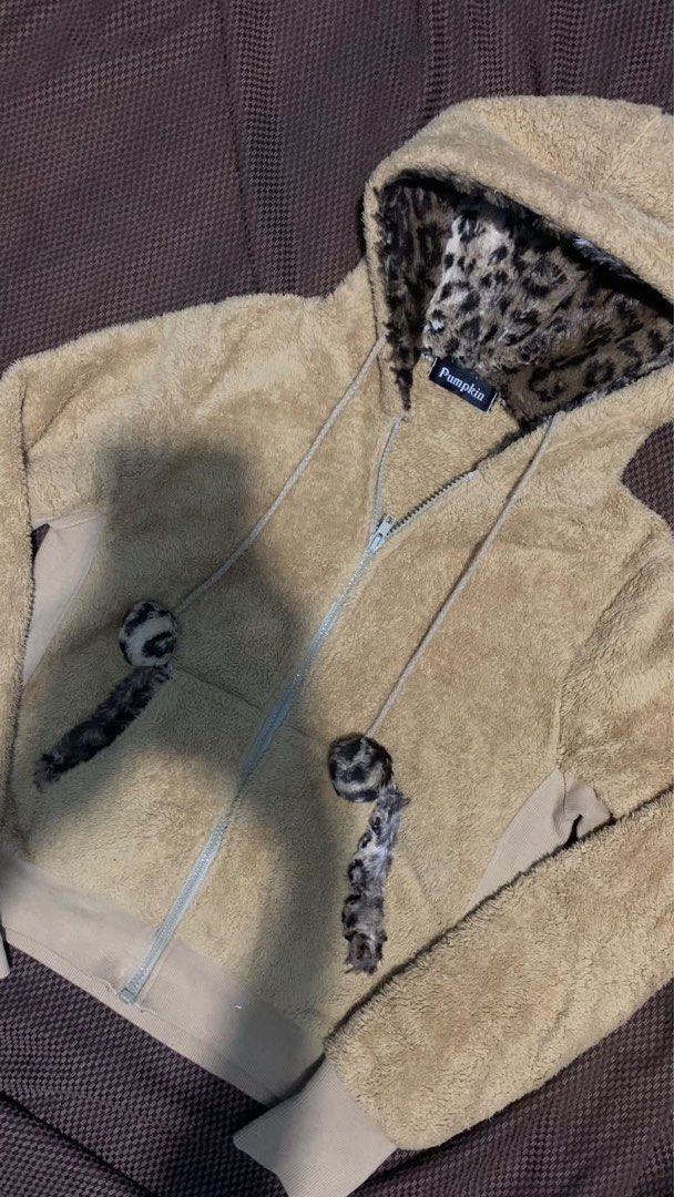 Leopard Zip Up Hoodie (Category: Coats, Jackets and Outerwear) located in Antipolo. Submitted by saintclairw_ (Listing ID 1465459944, Image 2). Description: - Brand/Style: Pumpkin fuzzy zip-up hoodie in cozy beige - Hood: Lined with a bold leopard print pattern and matching fuzzy pom-pom drawstrings - Comfort & Warmth: Ribbed cuffs and hem to lock in heat, plus a front split kangaroo pocket - Material: Super soft and fluffy fleece all over - Cond