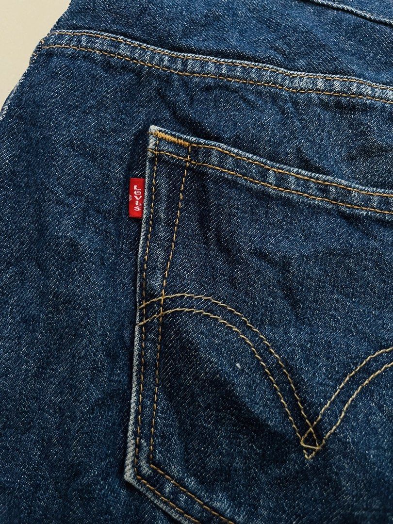 Levi's 505 Regular Fit Jeans W36 L32 (Category: Jeans) located in Manila. Submitted by bengirlclothing (Listing ID 1465578781, Image 3). Description: Classic Levi's 505 regular fit jeans in a medium dark blue wash. Made in Lesotho from 100 percent cotton denim. Features standard five-pocket styling, contrast yellow stitching, and the iconic red tab on the back pocket. Tagged waist 36, length 32..
