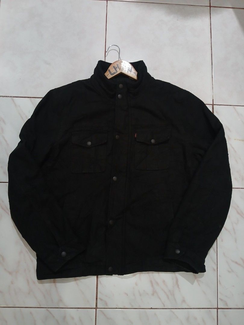 Levi's Black Casual Button-Up Jacket Size M (Category: Coats, Jackets and Outerwear) located in Taguig. Submitted by thriftnilhan (Listing ID 1465404831, Image 1). Description: - Brand: Levi's - Color: Black - Size: Medium (M) - Closure: Snap buttons on front and cuffs - Pockets: Two chest pockets with snap buttons - Details: Signature red Levi's tab on left pocket, classic collar.