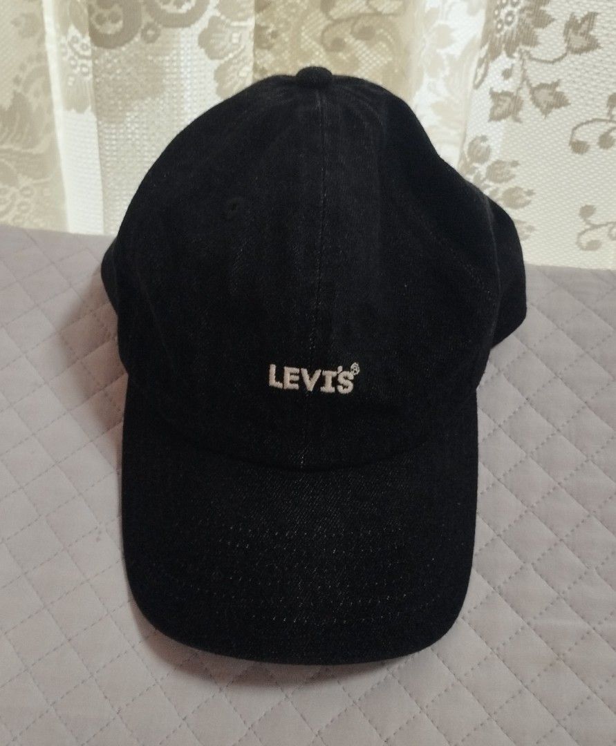 Levi's Black Denim Baseball Cap (Category: Caps & Hats) located in Baguio. Submitted by katgon2016 (Listing ID 1465446101, Image 1). Description: - Brand: Levi's - Color: Classic black denim - Material: 100% premium cotton - Design: Embroidered white Levi's logo on front - Details: Adjustable strap back with silver metal slider and iconic red Levi's tab - Fit: Standard one size fits most - Condition: Clean inside lining with original interior tag