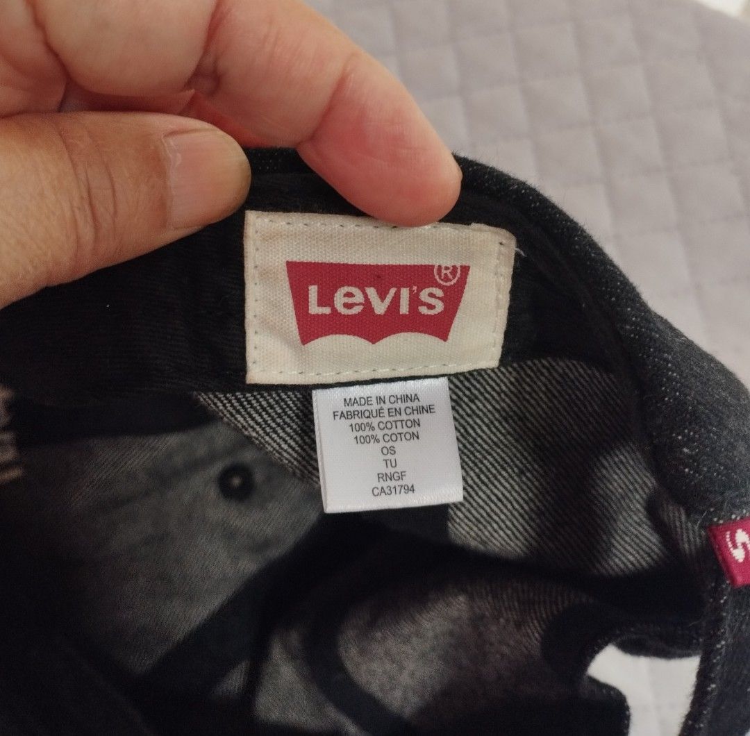 Levi's Black Denim Baseball Cap (Category: Caps & Hats) located in Baguio. Submitted by katgon2016 (Listing ID 1465446101, Image 2). Description: - Brand: Levi's - Color: Classic black denim - Material: 100% premium cotton - Design: Embroidered white Levi's logo on front - Details: Adjustable strap back with silver metal slider and iconic red Levi's tab - Fit: Standard one size fits most - Condition: Clean inside lining with original interior tag