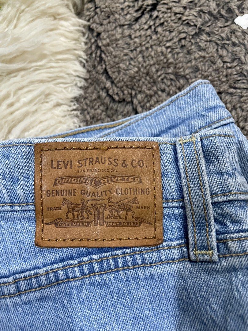 Levi's Ribcage Denim Shorts Size 32 (Category: Shorts) located in Catmon. Submitted by menchyyong97407 (Listing ID 1465404181, Image 3). Description: - Brand: Levi's - Style: Ribcage denim shorts - Color: Light blue wash - Size: 32 - Fit: High-waisted with button fly closure - Details: Distressed front pocket and leg hem, raw frayed hems, classic five-pocket styling, leather back patch, and signature red tab - Condition: Excellent/Ready to wear w