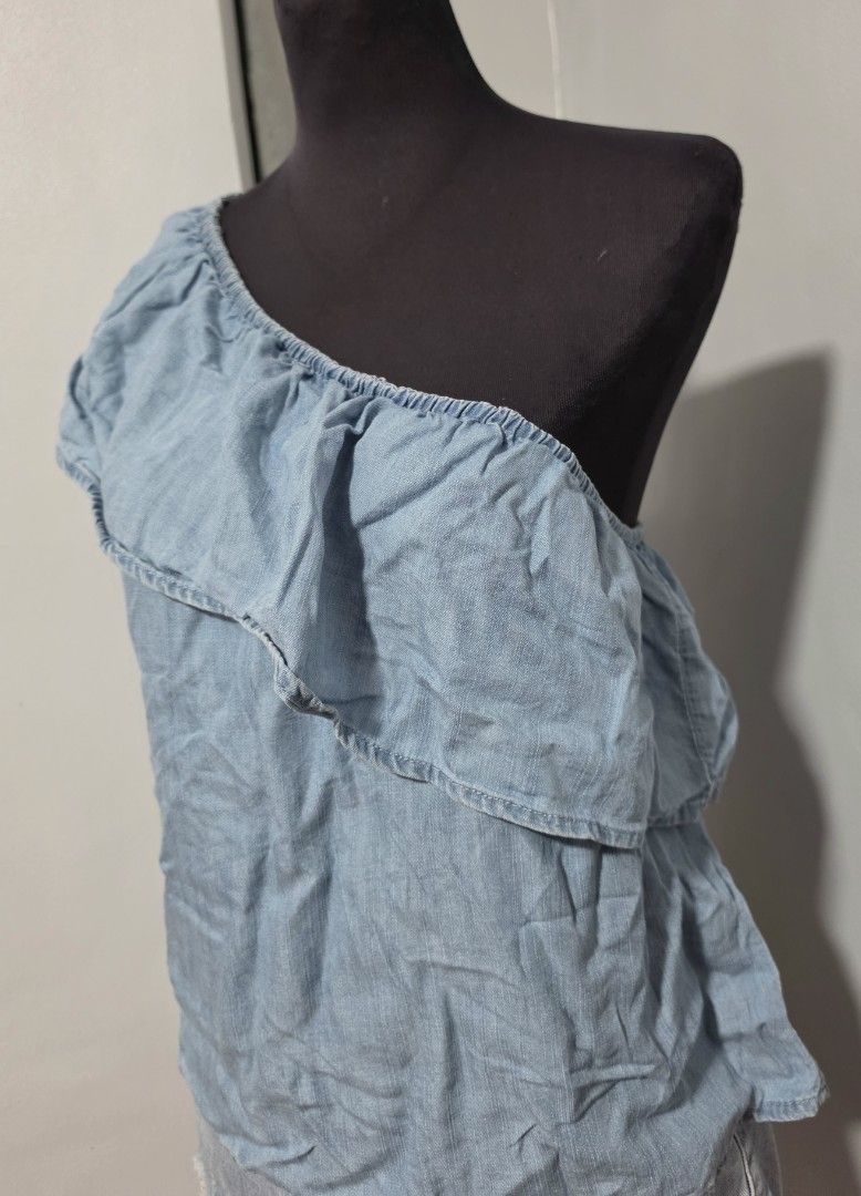 Light blue chambray one-shoulder ruffled top size S (Category: Sleeveless) located in Paranaque City. Submitted by franinnashop (Listing ID 1465441881, Image 2). Description: DECLUTTER SMALL TO MED PARANAQUE CITY - Color: Light blue denim-look (chambray) - Size: S (Made in India) - Design: One-shoulder with a wide ruffle layer front and back - Fit: Secure elastic neckline and top edge - Fabric: Soft, lightweight, and breezy - Styling: Great to pa