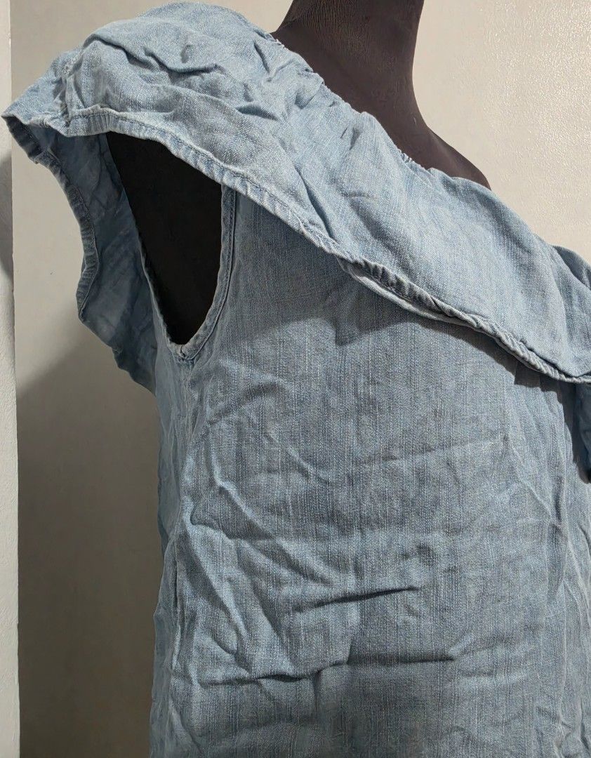 Light blue chambray one-shoulder ruffled top size S (Category: Sleeveless) located in Paranaque City. Submitted by franinnashop (Listing ID 1465441881, Image 3). Description: DECLUTTER SMALL TO MED PARANAQUE CITY - Color: Light blue denim-look (chambray) - Size: S (Made in India) - Design: One-shoulder with a wide ruffle layer front and back - Fit: Secure elastic neckline and top edge - Fabric: Soft, lightweight, and breezy - Styling: Great to pa