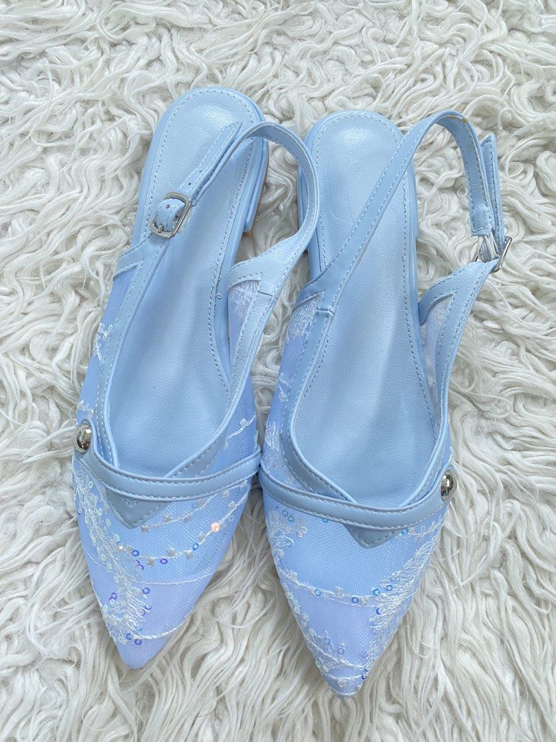 Light blue embroidered pointed-toe slingback flats with sequins (Category: Flats & Sandals) located in Tabaco. Submitted by camila_p (Listing ID 1465385614, Image 1). Description: - Color & Style: Baby blue pointed flats with a low stacked heel - Design: Mesh side panels with white floral embroidery and subtle sequin details - Fit: Adjustable slingback strap with a secure silver buckle - Condition: Brand new and unworn, with completely clean sole