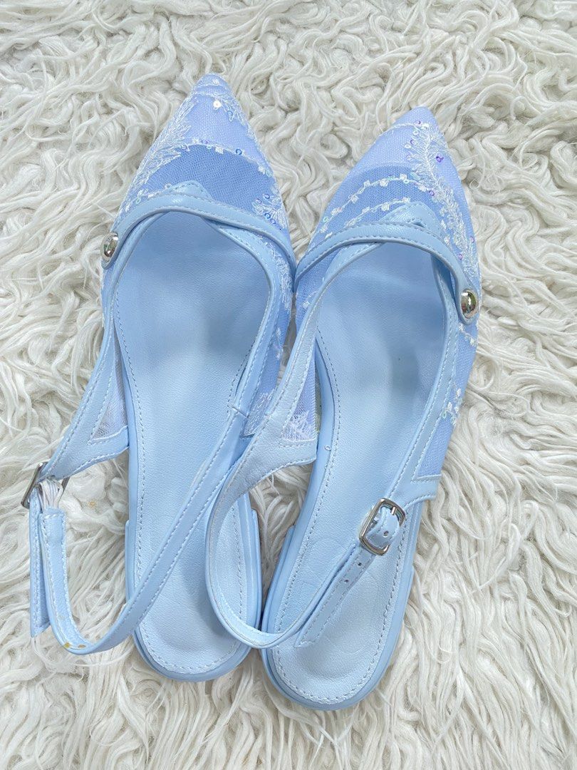 Light blue embroidered pointed-toe slingback flats with sequins (Category: Flats & Sandals) located in Tabaco. Submitted by camila_p (Listing ID 1465385614, Image 2). Description: - Color & Style: Baby blue pointed flats with a low stacked heel - Design: Mesh side panels with white floral embroidery and subtle sequin details - Fit: Adjustable slingback strap with a secure silver buckle - Condition: Brand new and unworn, with completely clean sole