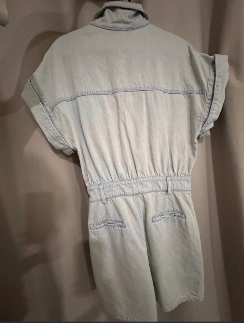 light wash denim short romper jumpsuit (Category: Rompers) located in Manila. Submitted by decluterthings888 (Listing ID 1465397489, Image 3). Description: - Style: Light wash denim short jumpsuit / romper - Details: Collared neck, button-front closure, rolled sleeve cuffs - Fit: Fitted waist with comfortable elastic and belt loops - Pockets: Functional chest pockets, front pockets, and back pockets - Condition: Excellent, ready to wear - Perfect