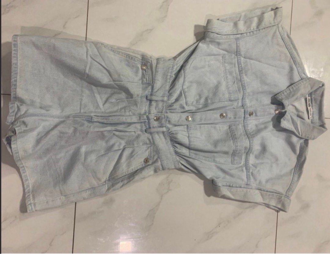 light wash denim short romper jumpsuit (Category: Rompers) located in Manila. Submitted by decluterthings888 (Listing ID 1465397489, Image 1). Description: - Style: Light wash denim short jumpsuit / romper - Details: Collared neck, button-front closure, rolled sleeve cuffs - Fit: Fitted waist with comfortable elastic and belt loops - Pockets: Functional chest pockets, front pockets, and back pockets - Condition: Excellent, ready to wear - Perfect