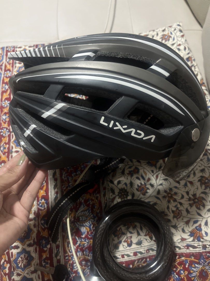 Lixada Cycling Helmet with Detachable Visor (Category: Bicycles) located in Pasig City. Submitted by jnzmrq1003 (Listing ID 1465519721, Image 1). Description: - Brand: Lixada - Color: Black and grey with white stripes - Includes a tinted magnetic detachable visor - Excellent ventilation with multiple top and side air vents - Adjustable straps with reflective details for night safety - Perfect for road cycling and daily commuting - Condition: Exce