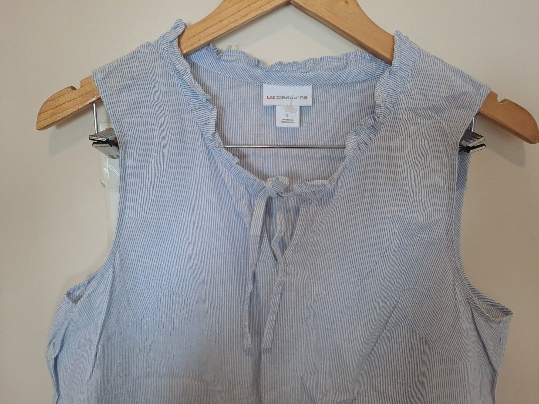 Liz Claiborne pinstripe sleevesless (Category: Blouses) located in Manila. Submitted by joanbalde39643 (Listing ID 1465442195, Image 2). Description: This is a Liz Claiborne sleeveless blue-and-white pinstripe top featuring white floral embroidery along the bottom and a ruffled keyhole neckline with tie details. 🌟.