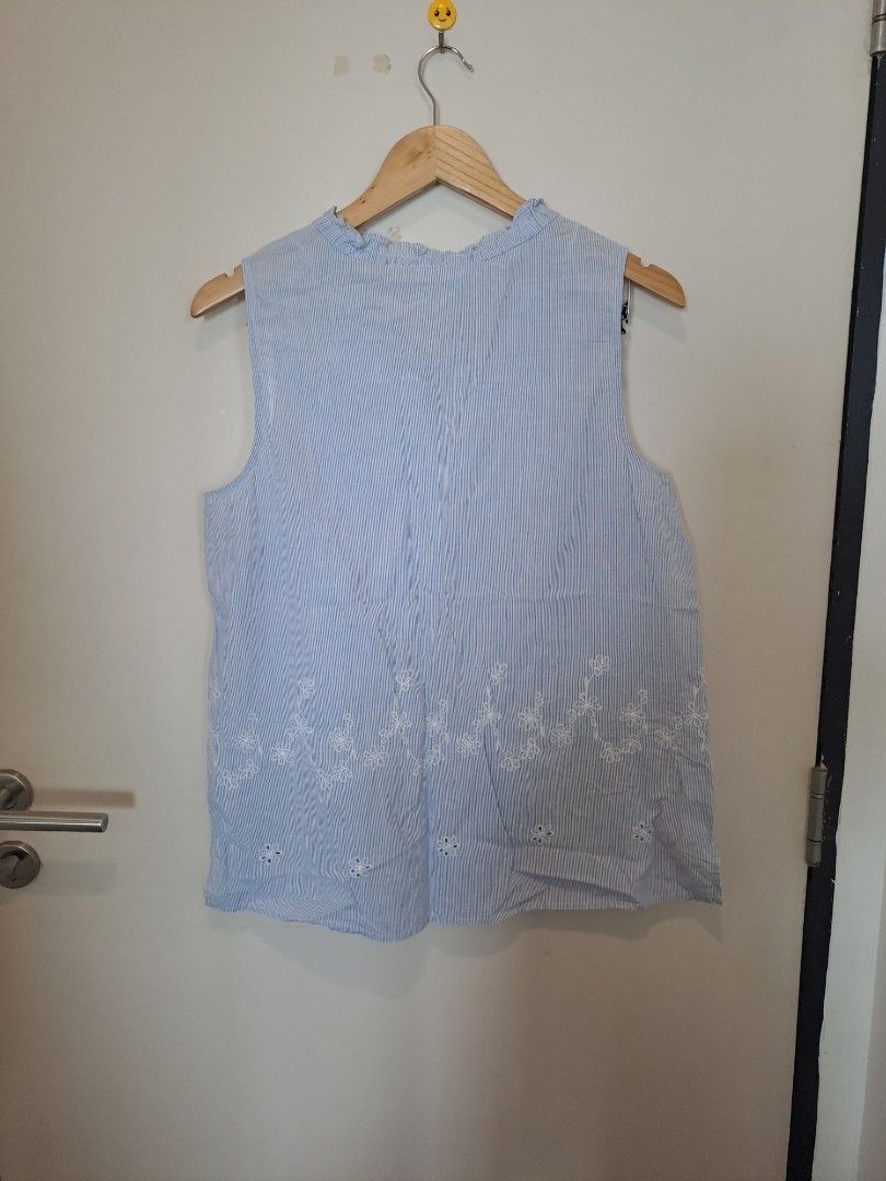 Liz Claiborne pinstripe sleevesless (Category: Blouses) located in Manila. Submitted by joanbalde39643 (Listing ID 1465442195, Image 3). Description: This is a Liz Claiborne sleeveless blue-and-white pinstripe top featuring white floral embroidery along the bottom and a ruffled keyhole neckline with tie details. 🌟.