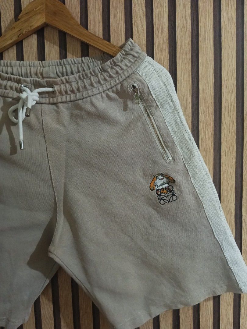 Loewe Beige Knit Side Stripe Sweat Shorts (Category: Shorts) located in Manila. Submitted by delavinjor93182 (Listing ID 1465419953, Image 2). Description: - Brand: Loewe - Color: Beige with white textured knit side panels - Material: Premium cotton - Features: Drawstring waist, secure zipped side pockets, branded zipper hardware - Details: Unique embroidered character patch with the Loewe Anagram logo on the left leg - Condition: Clean stitching