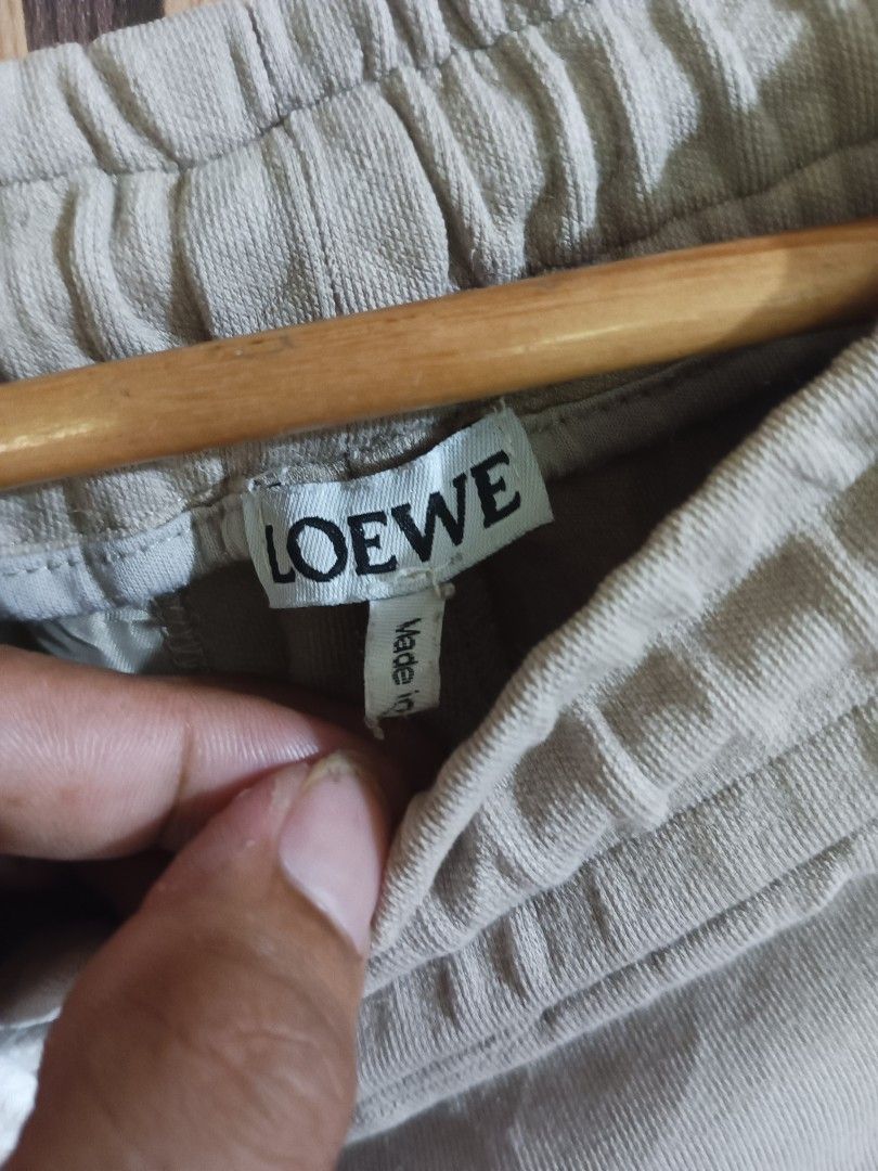 Loewe Beige Knit Side Stripe Sweat Shorts (Category: Shorts) located in Manila. Submitted by delavinjor93182 (Listing ID 1465419953, Image 3). Description: - Brand: Loewe - Color: Beige with white textured knit side panels - Material: Premium cotton - Features: Drawstring waist, secure zipped side pockets, branded zipper hardware - Details: Unique embroidered character patch with the Loewe Anagram logo on the left leg - Condition: Clean stitching