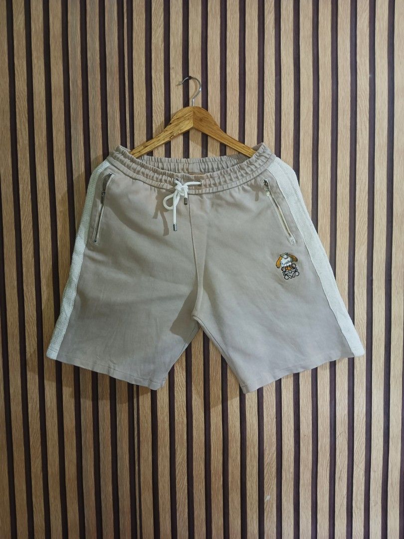 Loewe Beige Knit Side Stripe Sweat Shorts (Category: Shorts) located in Manila. Submitted by delavinjor93182 (Listing ID 1465419953, Image 1). Description: - Brand: Loewe - Color: Beige with white textured knit side panels - Material: Premium cotton - Features: Drawstring waist, secure zipped side pockets, branded zipper hardware - Details: Unique embroidered character patch with the Loewe Anagram logo on the left leg - Condition: Clean stitching