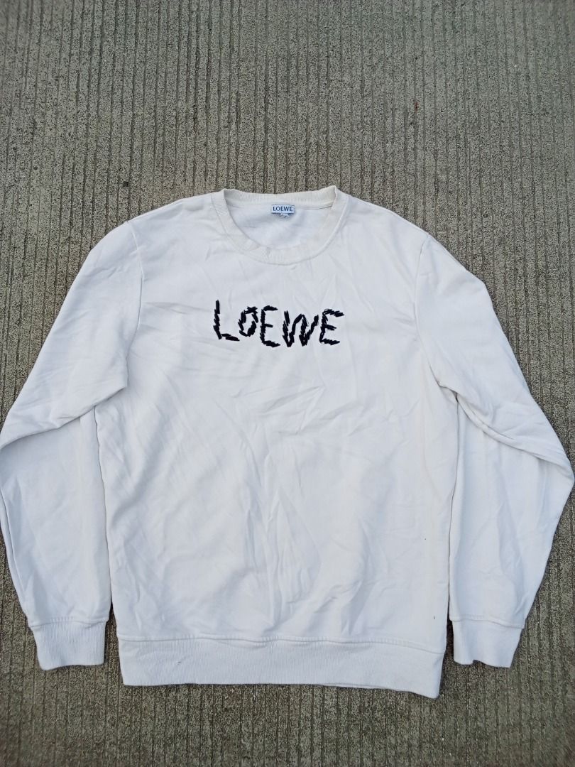 Loewe White Embroidered Logo Sweatshirt (Category: Luxury Apparel) located in Caloocan City. Submitted by mysticdog-6a6b (Listing ID 1465447930, Image 1). Description: - Brand: Loewe - Color: White with embroidered black lettering - Size: XL but fit to large - Material: 100% Cotton (Made in Portugal) - Style: Crewneck with ribbed cuffs and hem - Condition: Good, with minor yellowing near the collar from previous wear - Authentic luxury piece read