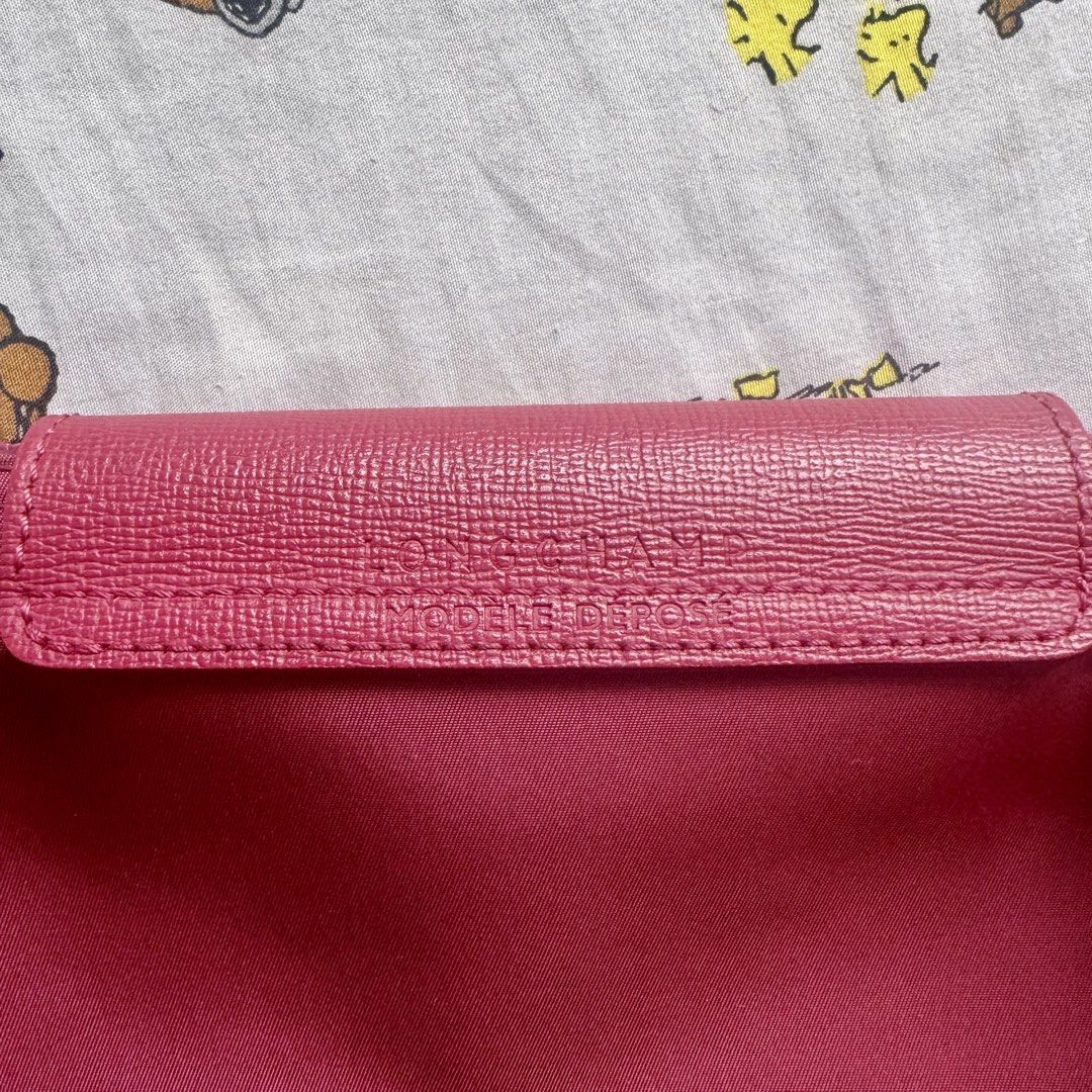 Longchamp Le Pliage Neo Medium Tote Bag (Category: Luxury Bags & Wallets) located in Marikina City. Submitted by preloved_n_reloved (Listing ID 1465416349, Image 3). Description: - Brand: Longchamp Le Pliage - Color: Raspberry/Framboise - Hardware: Silver-toned with horse logo engraving - Closure: Snap button and zipper - Condition: Needs cleaning - Features: Lightweight, spacious, perfect for daily use.
