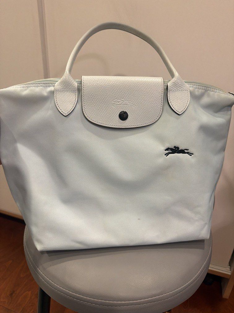 Longchamp Le Pliage Nylon Tote Bag Light Blue (ORIGINAL) (Category: Luxury Bags & Wallets) located in Pasig City. Submitted by bernamascarinas (Listing ID 1464972277, Image 3). Description: Still in good condition.. but theres signs of usage. Bought this for 7,000 selling low - Authentic Longchamp Le Pliage tote bag in a lovely light blue shade - Designed with long shoulder straps for comfortable everyday wear - Secure top zipper and snap flap cl