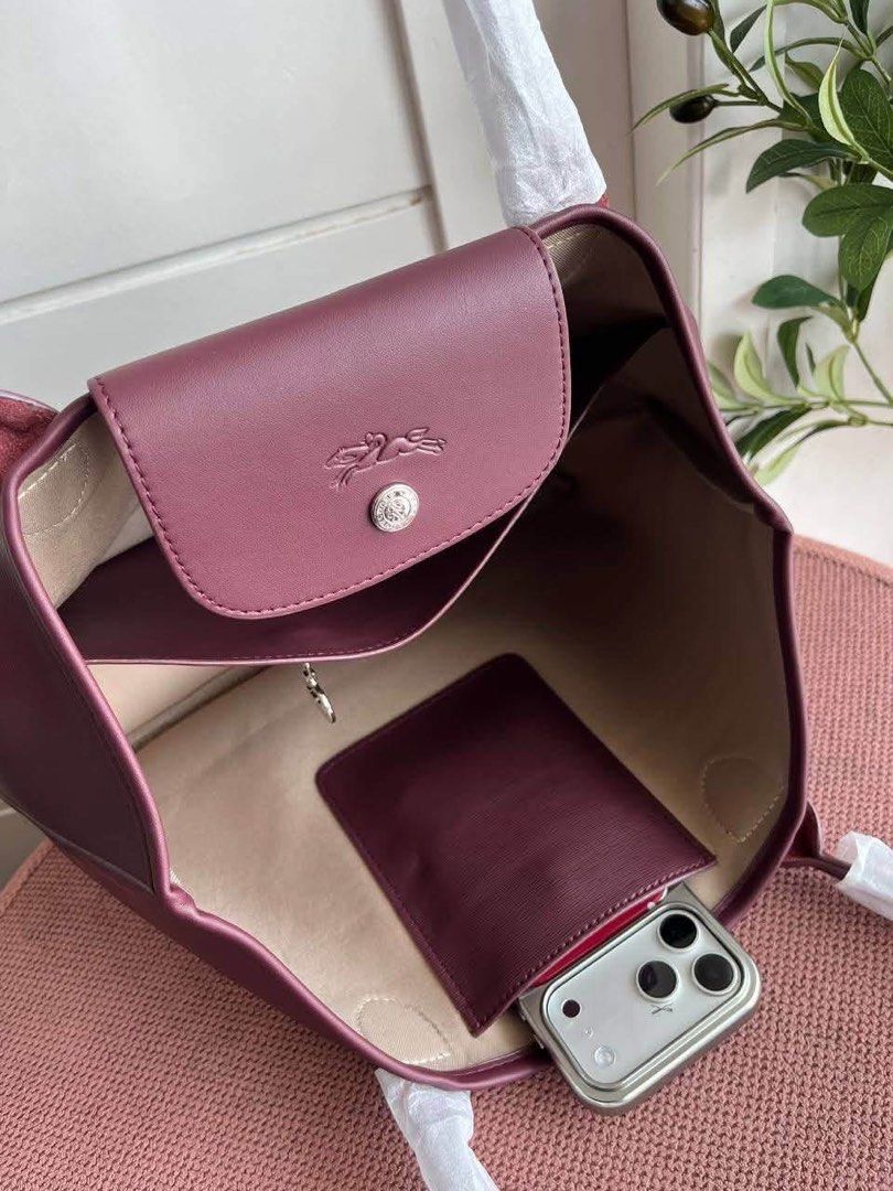 Longchamp Tote Large (Category: Luxury Bags & Wallets) located in Manila. Submitted by liahsells (Listing ID 1465404611, Image 3). Description: - Brand: Longchamp - Colors: Black, Beige, Blue, Orange, Muted Red - Style: Roomy daily tote bag - Features: Double handles (wrapped in protective paper), snap button closure with embossed logo flap - Interior: Light beige fabric lining with 1 zipped pocket and slip compartments - Condition: Brand new .