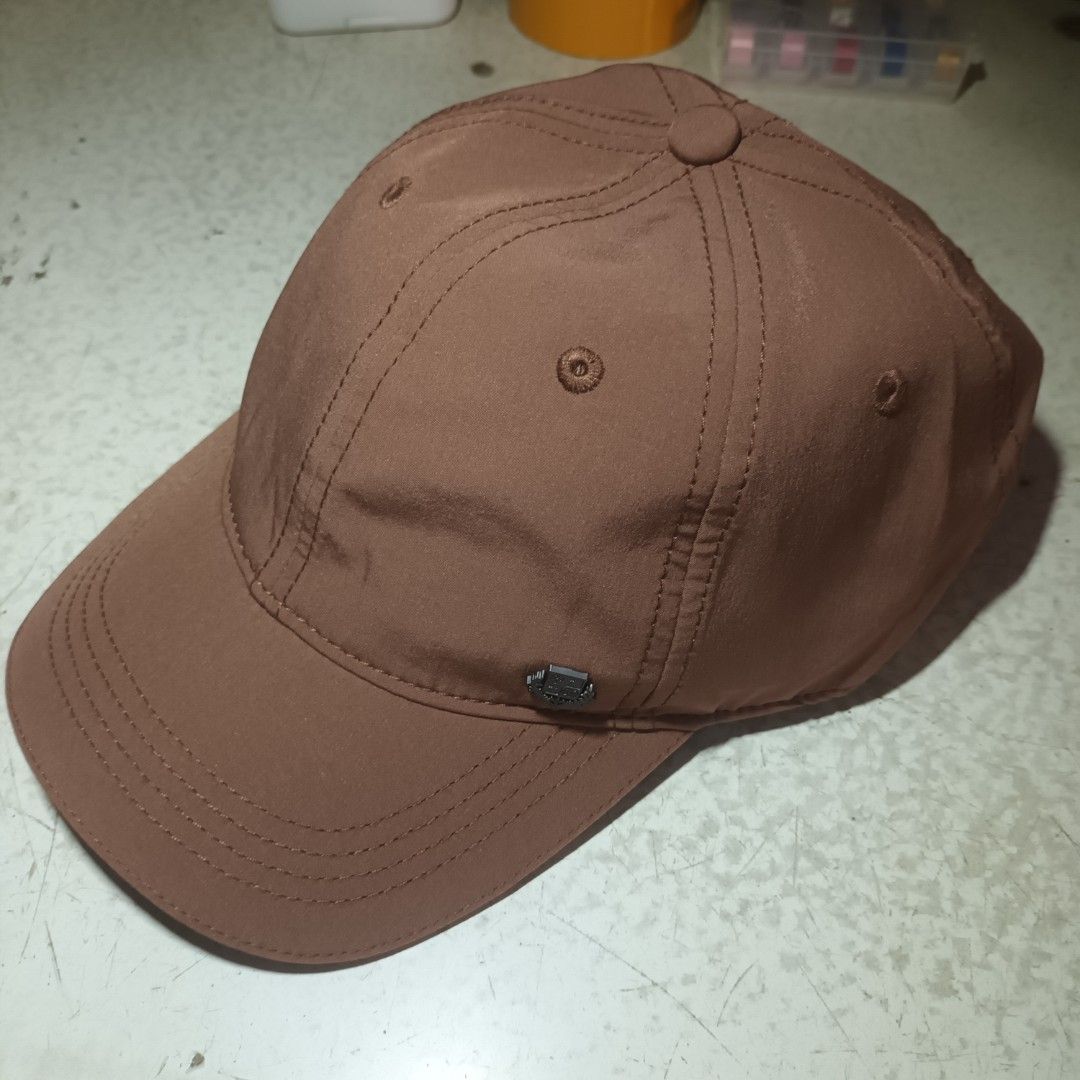 Loro Piana Brown Cap (Category: Caps & Hats) located in Manila. Submitted by itsnik444 (Listing ID 1465578438, Image 3). Description: - Color: Brown with a stylish black metallic logo badge - Material: 100% polyester (clean inside and out) - Fit: One size with an elastic back strap for comfort - Design: Classic curved brim and stitched panel details - Condition: Excellent, ready to wear.