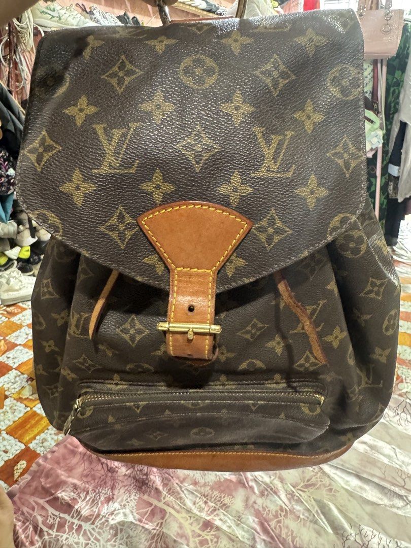 Louis Vuitton Backpack Genuine Leather (Category: Luxury Bags & Wallets) located in Manila. Submitted by wildbear.e10374 (Listing ID 1465439146, Image 1). Description: Louis Vuitton Monogram canvas backpack with brown leather trim and gold-tone hardware. Flap top with buckle closure, drawstring cinch top, and front zip pocket. Adjustable brown canvas and leather shoulder straps. Classic monogram pattern throughout..