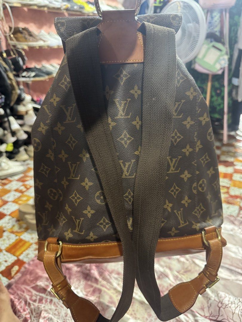 Louis Vuitton Backpack Genuine Leather (Category: Luxury Bags & Wallets) located in Manila. Submitted by wildbear.e10374 (Listing ID 1465439146, Image 3). Description: Louis Vuitton Monogram canvas backpack with brown leather trim and gold-tone hardware. Flap top with buckle closure, drawstring cinch top, and front zip pocket. Adjustable brown canvas and leather shoulder straps. Classic monogram pattern throughout..