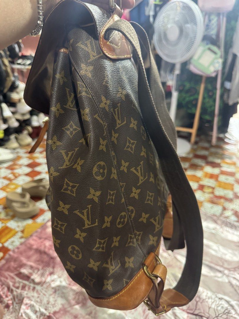Louis Vuitton Backpack Genuine Leather (Category: Luxury Bags & Wallets) located in Manila. Submitted by wildbear.e10374 (Listing ID 1465439146, Image 2). Description: Louis Vuitton Monogram canvas backpack with brown leather trim and gold-tone hardware. Flap top with buckle closure, drawstring cinch top, and front zip pocket. Adjustable brown canvas and leather shoulder straps. Classic monogram pattern throughout..