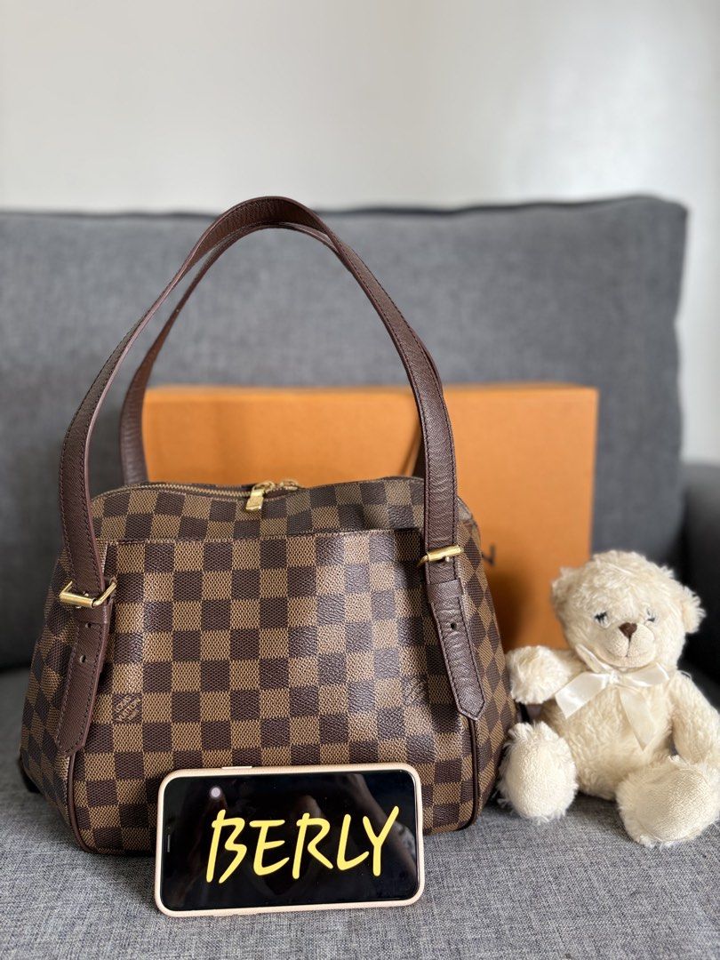 Louis Vuitton Damier Ebene Triana Handbag (Category: Luxury Bags & Wallets) located in Alicia. Submitted by berly06 (Listing ID 1465470165, Image 1). Description: - Authentic Louis Vuitton Triana bag - Iconic Damier Ebene canvas with dark brown leather handles - Shiny gold-tone hardware with LV zip pulls - Dual zip closure with structured shape - Vibrant red textile interior with a slip pocket and embossed logo - Clean inside and well-maintained 