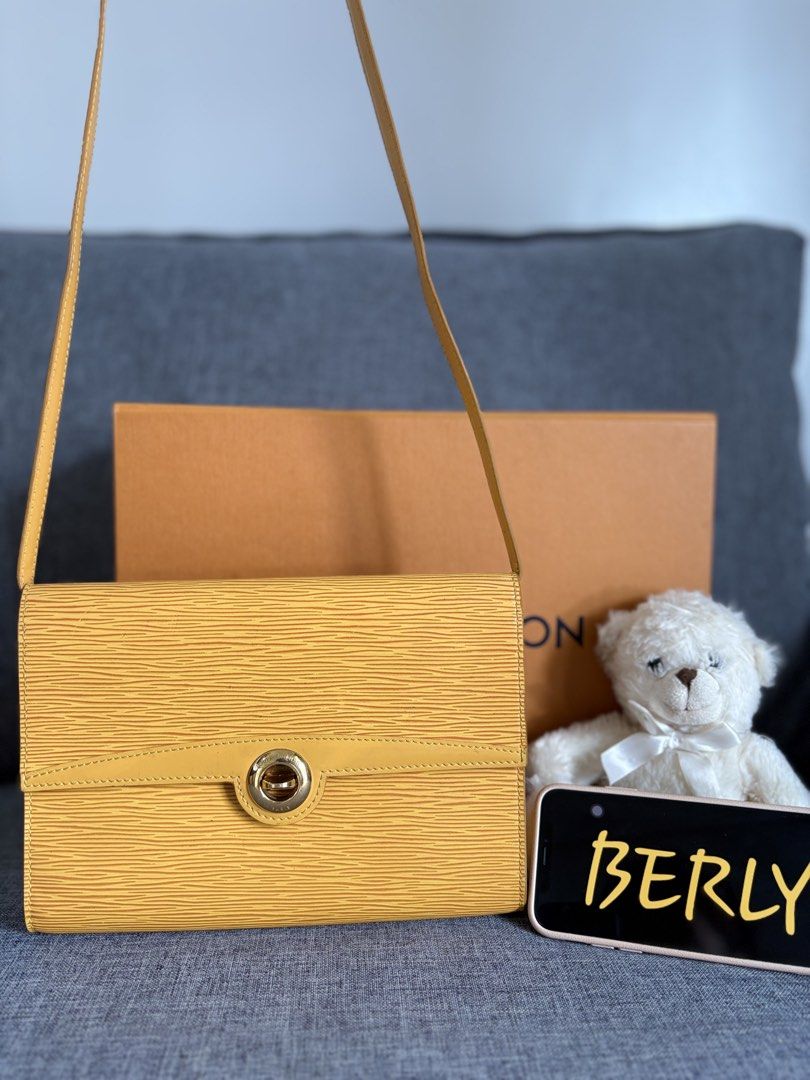 Louis Vuitton Epi Leather Yellow Shoulder Bag (Category: Luxury Bags & Wallets) located in Alicia. Submitted by berly06 (Listing ID 1465469577, Image 1). Description: - Authentic Louis Vuitton Epi leather bag in a striking bright yellow - Structured rectangular design with a comfortable long shoulder strap - Secure gold-tone twist lock closure engraved with Louis Vuitton Paris - Durable and textured signature Epi leather grain - Includes original