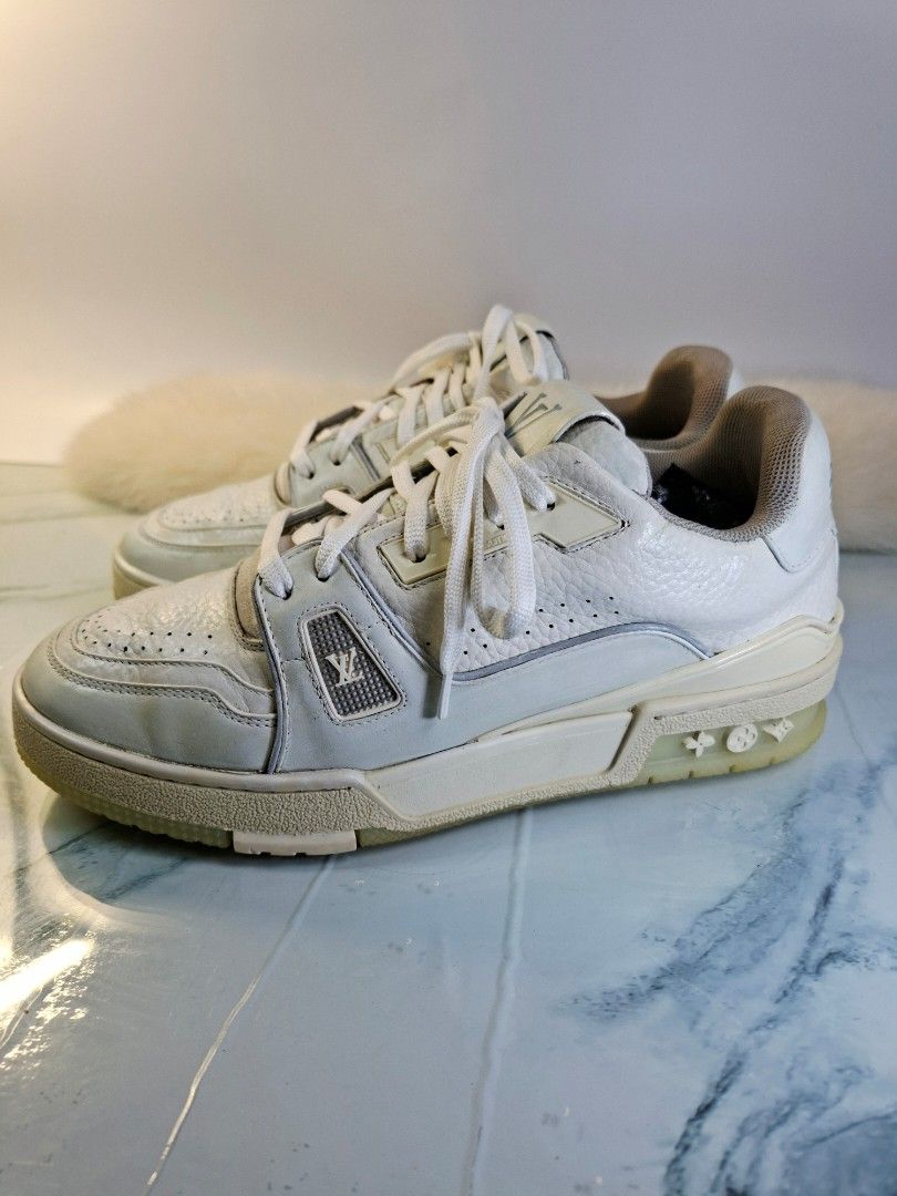 Louis Vuitton LV Trainer White Sneakers (Category: Sneakers) located in Pasay City. Submitted by onick_79 (Listing ID 1465545999, Image 3). Description: - Brand: Louis Vuitton - Color: Classic White - Material: leather with textured pebble leather panels - Details: Embossed monogram on midsole, LV branding on tongue and heel counter - Closure: Lace-up with white laces - Sole: Flat rubber sole - Condition: Good, with visible wear on the tongue and