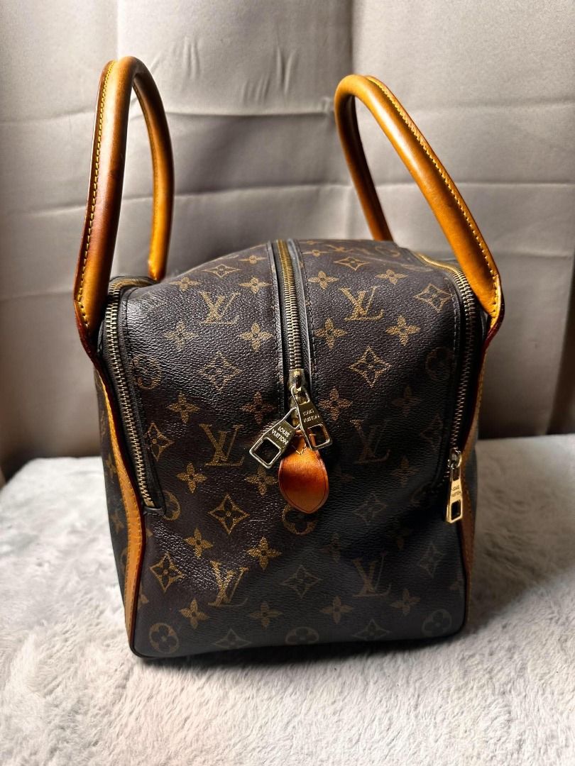 Louis Vuitton Monogram Canvas Handbag (Category: Luxury Bags & Wallets) located in Davao. Submitted by luckyturtle.aa6ccf (Listing ID 1465392657, Image 2). Description: - Classic Louis Vuitton Monogram canvas with rich brown leather handles - Secure top zip closure with dual pull tabs - Structured square base with protective feet and snap-button exterior strap - Spacious deep plum interior lining with Louis Vuitton Paris heat stamp - Premium gold