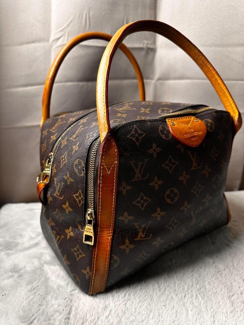 Louis Vuitton Monogram Canvas Handbag (Category: Luxury Bags & Wallets) located in Davao. Submitted by luckyturtle.aa6ccf (Listing ID 1465392657, Image 3). Description: - Classic Louis Vuitton Monogram canvas with rich brown leather handles - Secure top zip closure with dual pull tabs - Structured square base with protective feet and snap-button exterior strap - Spacious deep plum interior lining with Louis Vuitton Paris heat stamp - Premium gold