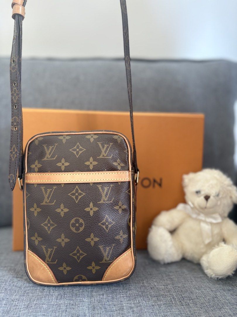 Louis Vuitton Monogram Danubio Crossbody Bag (Category: Luxury Bags & Wallets) located in Alicia. Submitted by berly06 (Listing ID 1465470481, Image 2). Description: - Authentic Louis Vuitton Danubio messenger bag in signature brown monogram canvas - Structured vertical design with a convenient front slip pocket - Secure zip-around closure and clean interior lining - Adjustable leather shoulder strap and classic Vachetta leather trim - Includes o