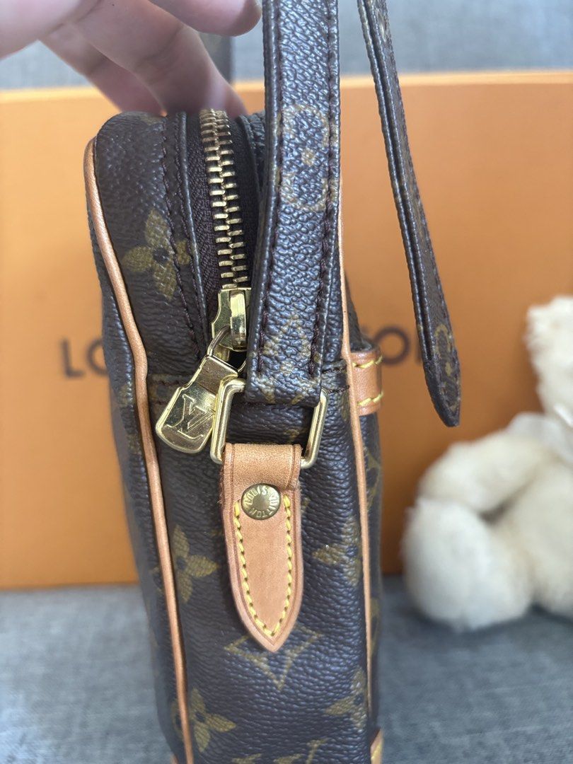 Louis Vuitton Monogram Danubio Crossbody Bag (Category: Luxury Bags & Wallets) located in Alicia. Submitted by berly06 (Listing ID 1465470481, Image 3). Description: - Authentic Louis Vuitton Danubio messenger bag in signature brown monogram canvas - Structured vertical design with a convenient front slip pocket - Secure zip-around closure and clean interior lining - Adjustable leather shoulder strap and classic Vachetta leather trim - Includes o