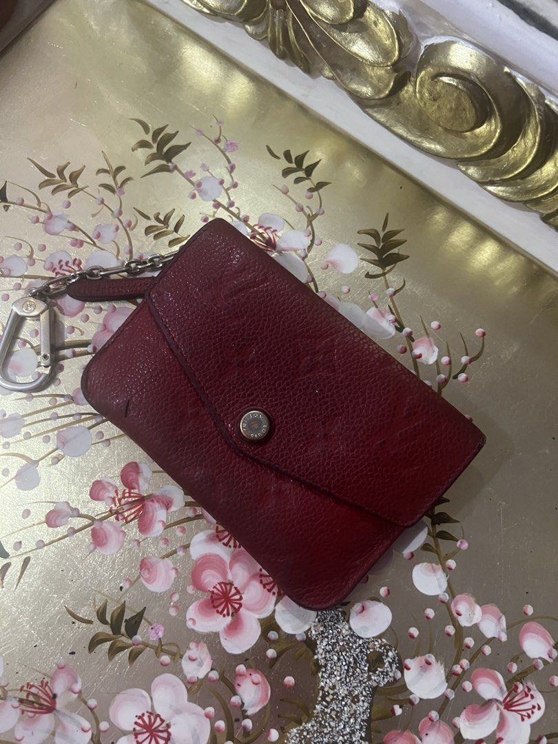 Louis Vuitton Red Leather Wallet (Category: Luxury Bags & Wallets) located in Cebu City. Submitted by shofaholicz (Listing ID 1465455069, Image 1). Description: - Brand: Louis Vuitton - Color: Red with gold-tone hardware - Closure: Front flap with snap button - Compartments: Exterior zip pocket on the back - Feature: Attached metal chain with clasp hook - Authenticity: Louis Vuitton Paris made in France heat stamp and gold-stamped date code TN119