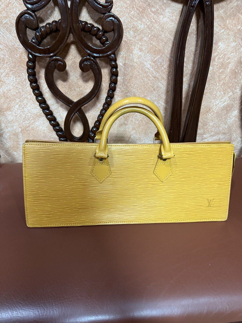 Louis Vuitton Yellow Epi Leather Triangle Handbag (Category: Luxury Bags & Wallets) located in Manila. Submitted by indaykalakal0408 (Listing ID 1465489949, Image 2). Description: Sa halagang 10,999 may tunay ka ng LV!!!! SUPER MURA NA!!! Binagsak ko na presyo!!! Grab nyo na. Previous selling price is 15,500. Malinis labas at loob, yung bakbak sa bulsa walang chipping off. Mabango!!! Louis Vuitton triangle bag in mango yellow Epi leather. Distinc