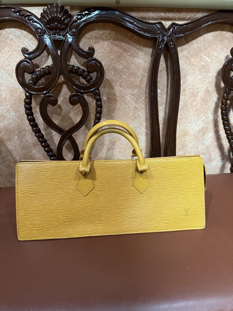 Louis Vuitton Yellow Epi Leather Triangle Handbag (Category: Luxury Bags & Wallets) located in Manila. Submitted by indaykalakal0408 (Listing ID 1465489949, Image 1). Description: Sa halagang 10,999 may tunay ka ng LV!!!! SUPER MURA NA!!! Binagsak ko na presyo!!! Grab nyo na. Previous selling price is 15,500. Malinis labas at loob, yung bakbak sa bulsa walang chipping off. Mabango!!! Louis Vuitton triangle bag in mango yellow Epi leather. Distinc