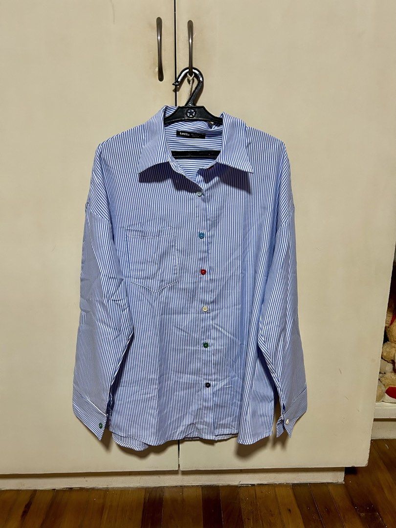 Lovito Blue White Striped Button Down Shirt (Category: Longsleeves) located in Makati City. Submitted by monicavazquez (Listing ID 1465485861, Image 1). Description: Lovito oversized blue and white striped long sleeve shirt with a classic collar, chest pocket, and cute colorful mismatch buttons..