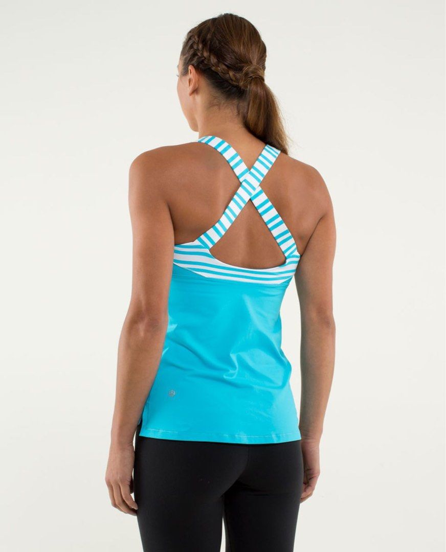 Lululemon Blue Stripe Cross-Back Tank Top size 4 (Category: Activewear) located in Rosales. Submitted by dariang22 (Listing ID 1465414546, Image 1). Description: - Brand: Lululemon - Color: Bright blue with white and blue striped cross-back straps - Features: Built-in shelf bra, lightweight stretchy fabric, and reflective logo on the lower left hem - Condition: Brand new with tags attached - Ideal for: Workouts, yoga, and active wear.