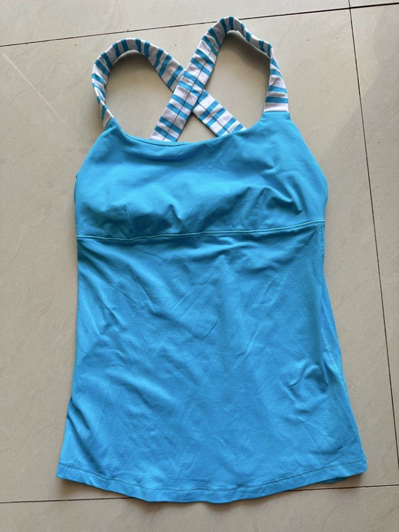 Lululemon Blue Stripe Cross-Back Tank Top size 4 (Category: Activewear) located in Rosales. Submitted by dariang22 (Listing ID 1465414546, Image 3). Description: - Brand: Lululemon - Color: Bright blue with white and blue striped cross-back straps - Features: Built-in shelf bra, lightweight stretchy fabric, and reflective logo on the lower left hem - Condition: Brand new with tags attached - Ideal for: Workouts, yoga, and active wear.