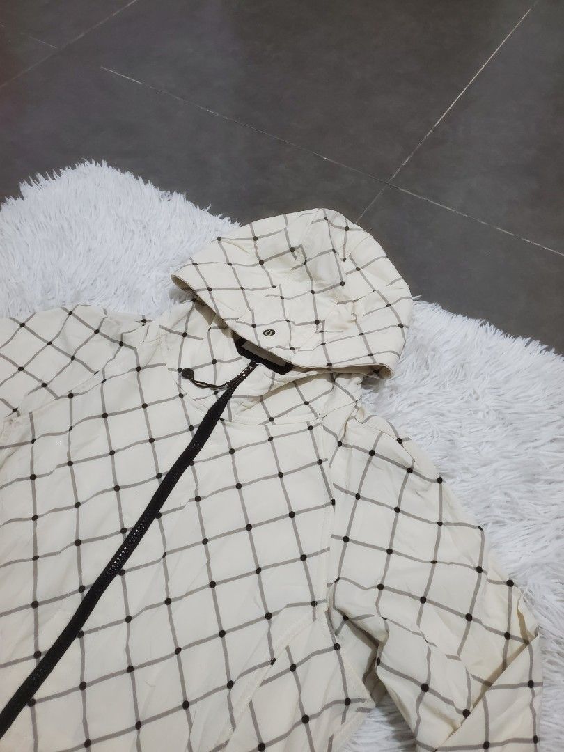 Lululemon Cream Plaid Checkered Long Trench Jacket Coat (Category: Coats, Jackets and Outerwear) located in Manila. Submitted by royalrabbit.7b2a11 (Listing ID 1465515905, Image 2). Description: - Color/Pattern: Cream with dark plaid - Closure: Full zip front with branded pulls - Hood: Removable - Details: Adjustable drawstring toggle with signature logo hardware - Fabric: Lightweight, great for layering - Condition: Clean, worn very few times - 