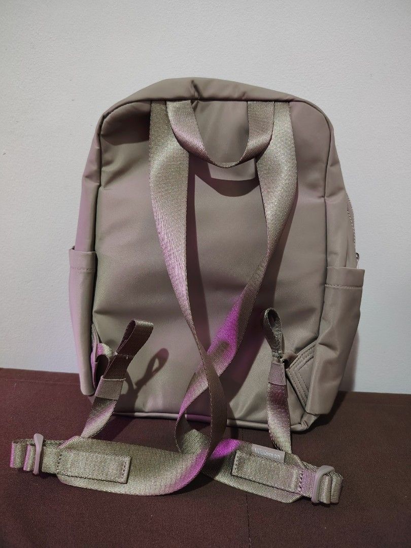 Lululemon Everyday Backpack Mini (Category: Backpacks) located in Mandaluyong City. Submitted by declutter_kween (Listing ID 1465523440, Image 2). Description: - Brand: Lululemon - Color: Neutral taupe grey - Material: Durable high-quality nylon - Compartments: Spacious main compartment, front zip pocket with metallic logo, side slip pockets - Interior: Clean lining with internal organization pockets - Straps: Adjustable shoulder straps with wove