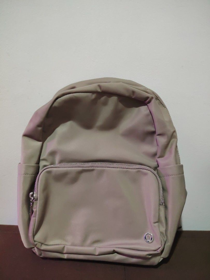 Lululemon Everyday Backpack Mini (Category: Backpacks) located in Mandaluyong City. Submitted by declutter_kween (Listing ID 1465523440, Image 1). Description: - Brand: Lululemon - Color: Neutral taupe grey - Material: Durable high-quality nylon - Compartments: Spacious main compartment, front zip pocket with metallic logo, side slip pockets - Interior: Clean lining with internal organization pockets - Straps: Adjustable shoulder straps with wove