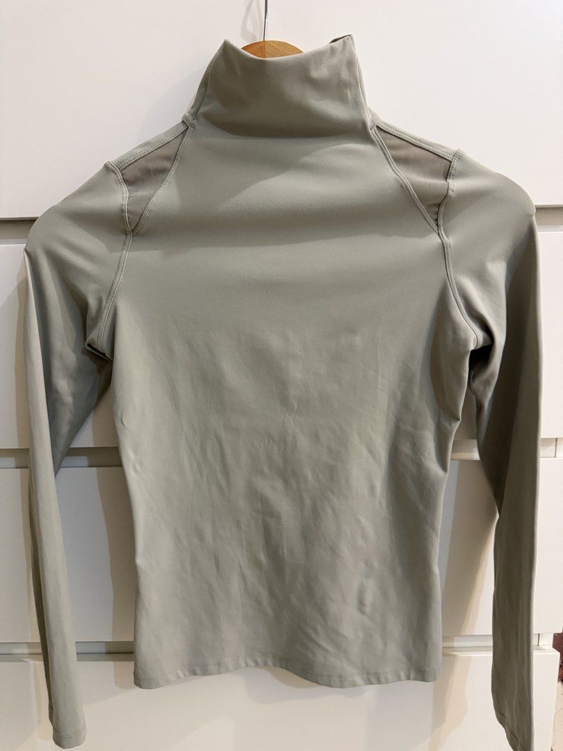 Lululemon Sage Green Turtleneck Long Sleeves (Category: Longsleeves) located in Makati City. Submitted by lvshop_mnl (Listing ID 1465408651, Image 1). Description: - Color: Sage green - Style: Fitted long sleeve top with a high turtleneck collar - Comfort: Highly stretchable fabric ideal for workouts or casual outfits - Feature: Breathable mesh shoulder panels for added ventilation - Finish: Clean-finished cuffs and hem for a sleek, minimalist lo