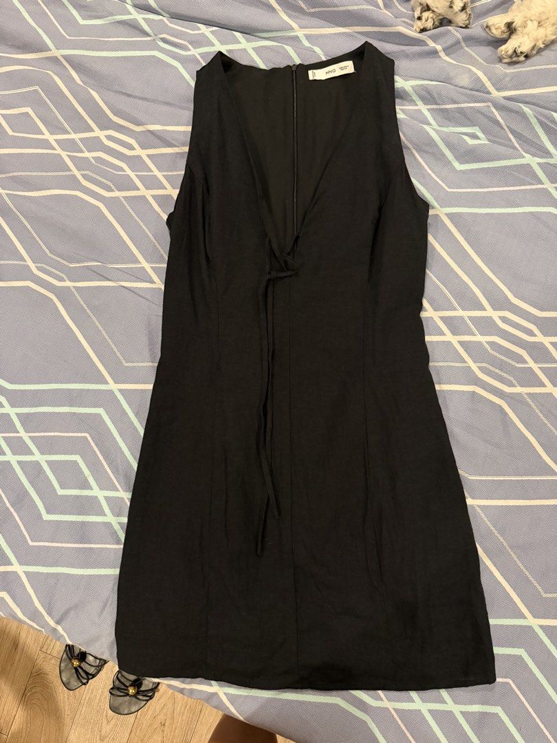 Mango Black V-Neck Tie Mini Dress (Category: Dresses) located in Bustos. Submitted by preloved_by_sasa (Listing ID 1465497404, Image 3). Description: - Brand: Mango - Style: Sleeveless mini dress with deep V-neck and front tie detail - Fit: Fitted body, hits above the knee, back zip closure - Color: Versatile solid black - Condition: Excellent / Like new - Perfect for: Dinner dates, night outs, and parties - RFS: Closet clear-out (PM for measurem